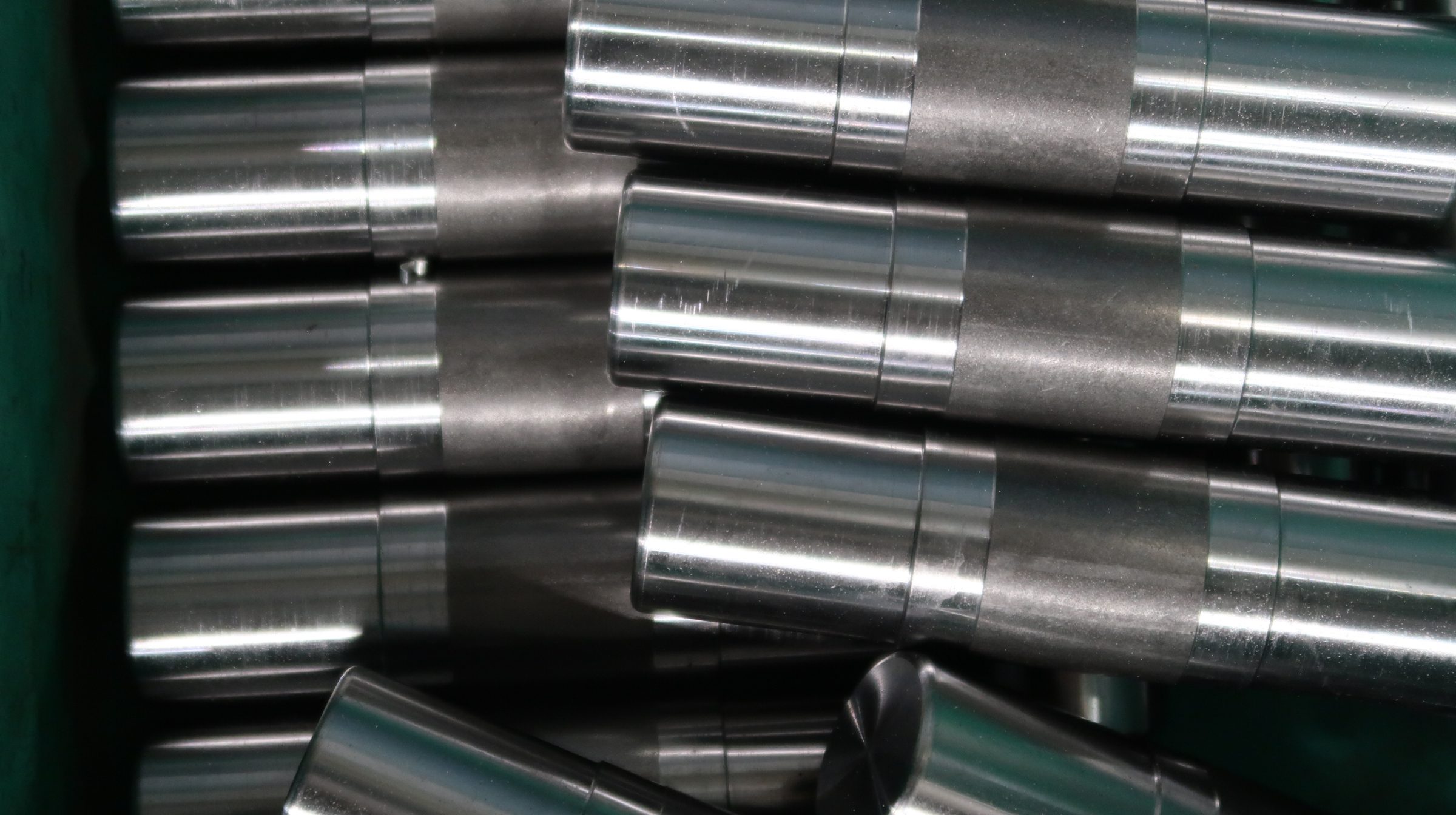 Several cylindrical parts in a bin.