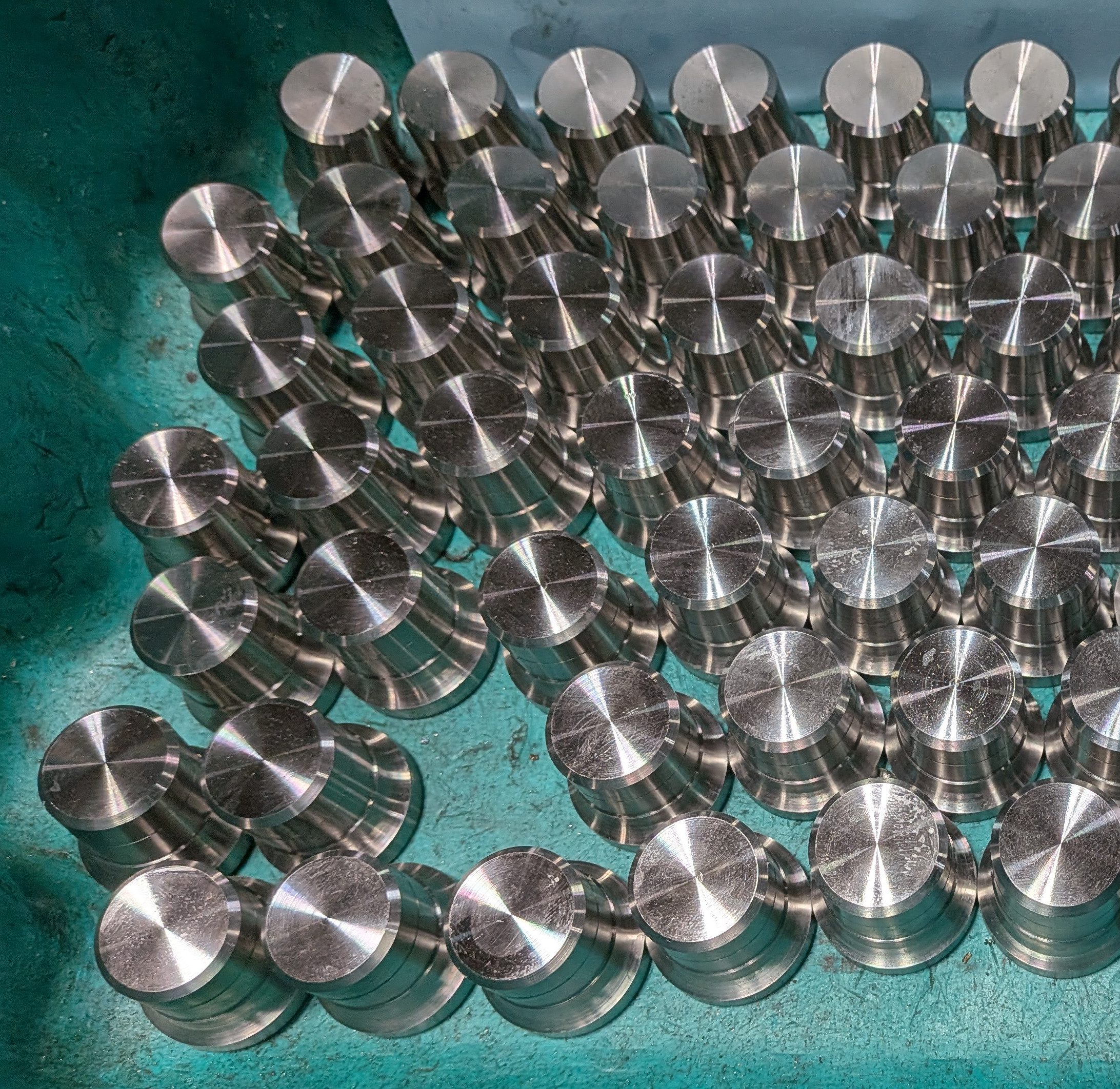 shiny metal parts in a bin